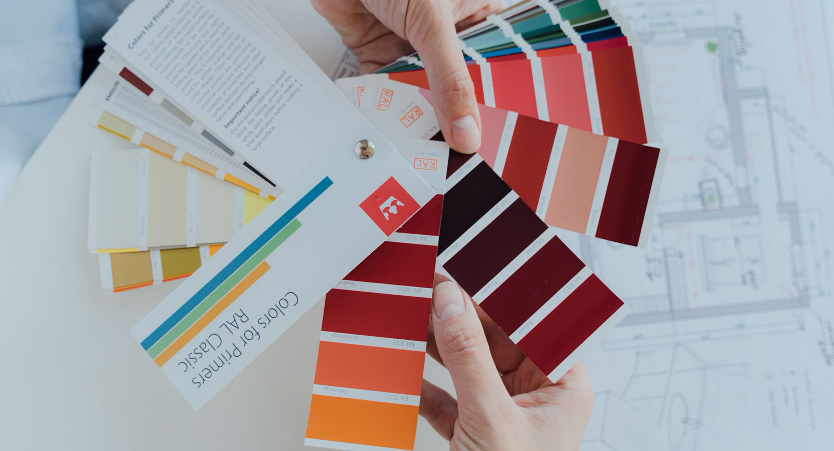 Person Holding Color Palettes 