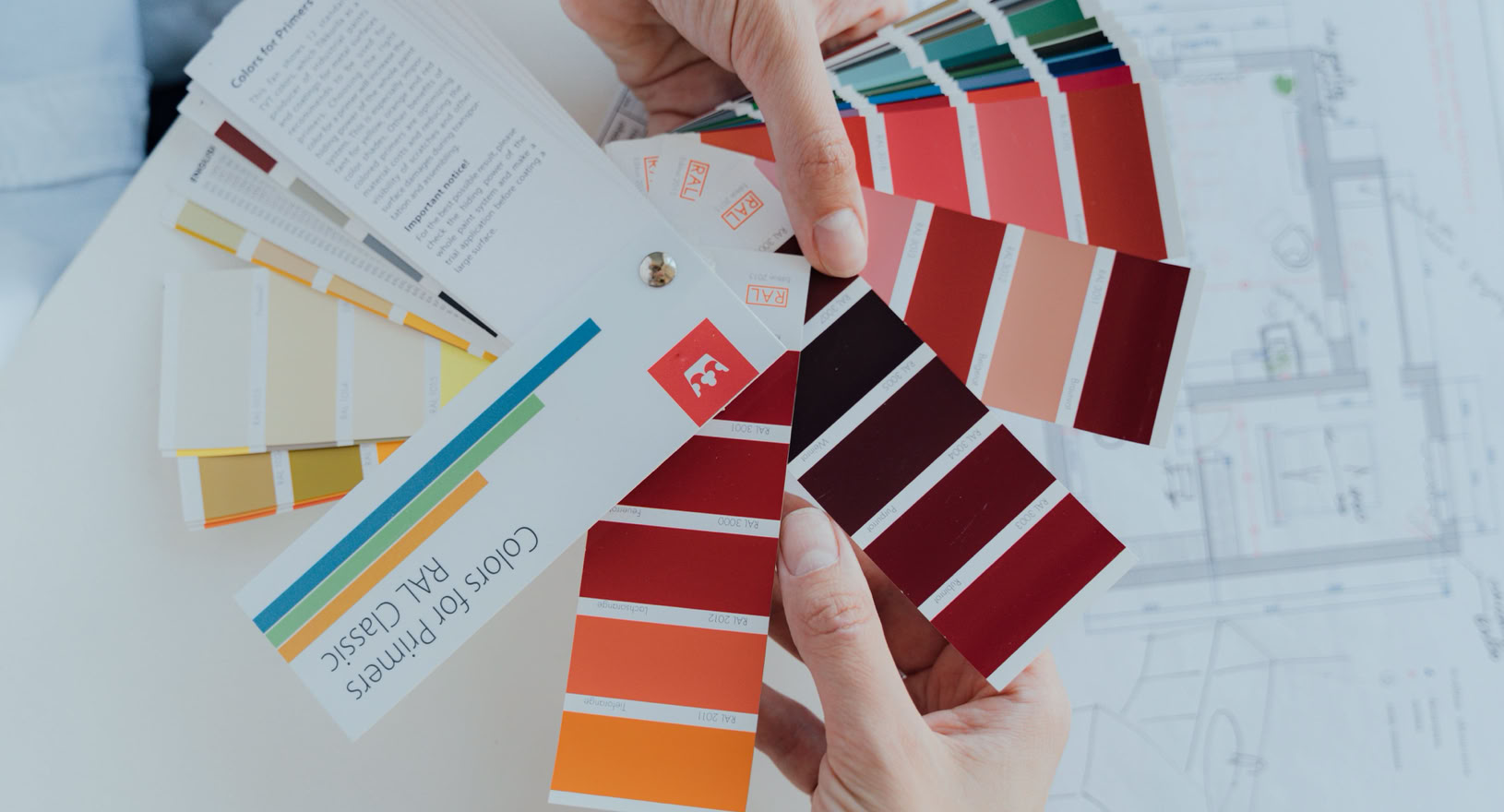 Person Holding Color Palettes 